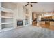 Open floor plan featuring a fireplace, built-in shelving, and a kitchen with a center island at 22436 E Maplewood Pl, Aurora, CO 80015