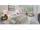 Bright main bedroom with a bay window, two chairs, and a nightstand at 22436 E Maplewood Pl, Aurora, CO 80015