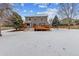 Spacious backyard with deck and snowy landscape at 5885 Cheetah Cv, Lone Tree, CO 80124