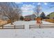 Large backyard with snow, deck and wooden fence at 5885 Cheetah Cv, Lone Tree, CO 80124