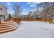 Backyard with deck, playset and snowy lawn at 5885 Cheetah Cv, Lone Tree, CO 80124