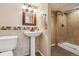 Basement bathroom with pedestal sink, shower, and tile flooring at 5885 Cheetah Cv, Lone Tree, CO 80124