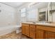 Bathroom boasts wood cabinets and a bathtub at 5885 Cheetah Cv, Lone Tree, CO 80124