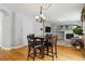 Dining area with hardwood floors and a chandelier, near a fireplace at 5885 Cheetah Cv, Lone Tree, CO 80124