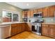 Kitchen with wood cabinets, stainless steel appliances, and hardwood floors at 5885 Cheetah Cv, Lone Tree, CO 80124