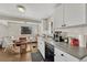 Eat-in kitchen with white cabinetry and a dishwasher at 2031 Meade St, Denver, CO 80211