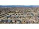 An aerial view of the neighborhood featuring various rooftops and tree coverage with distant mountains at 742 Megan Ct, Longmont, CO 80504