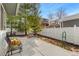 A concrete patio with chairs and a view of the fenced backyard with mature trees at 742 Megan Ct, Longmont, CO 80504