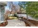 Backyard with a well-manicured lawn, mature trees and landscaping, and a patio with seating at 742 Megan Ct, Longmont, CO 80504