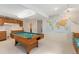 Finished basement with a billiards table, kitchenette and unique map-themed decor at 742 Megan Ct, Longmont, CO 80504