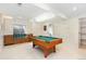 Recreational basement room equipped with a pool table and built-in seating area at 742 Megan Ct, Longmont, CO 80504