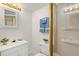 Bathroom with a framed mirror, white vanity, and a shower stall with glass doors at 742 Megan Ct, Longmont, CO 80504