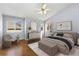 Inviting bedroom with hardwood floors, vaulted ceiling, ample natural light, and thoughtfully chosen decor at 742 Megan Ct, Longmont, CO 80504
