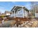 Side view of a well-maintained home showcasing the inviting front porch and lovely landscaping at 742 Megan Ct, Longmont, CO 80504