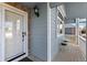 Inviting front porch featuring a sitting area, a storm door, and elegant exterior lighting at 742 Megan Ct, Longmont, CO 80504