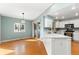 Bright kitchen with wood floors, white cabinets, stainless steel appliances, and sliding door to the outdoor area at 742 Megan Ct, Longmont, CO 80504