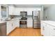 Well-equipped kitchen with stainless steel appliances, white cabinets, and stone countertops at 742 Megan Ct, Longmont, CO 80504