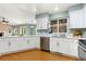 Bright kitchen with white cabinets, granite countertops, stainless steel appliances, and hardwood floors at 742 Megan Ct, Longmont, CO 80504