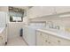 Functional laundry room featuring a sink, ample counter space, and a modern washer and dryer at 742 Megan Ct, Longmont, CO 80504