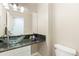 Stylish powder room with a unique glass vessel sink, granite countertop, and modern fixtures, and access to the main room at 742 Megan Ct, Longmont, CO 80504