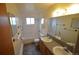 Bright bathroom with double sinks and a full tub and shower, offers plenty of space at 8450 Mason Cir, Westminster, CO 80031
