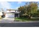 Charming two-story home featuring an attached garage and a mature tree in the front yard at 8450 Mason Cir, Westminster, CO 80031