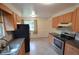 Well-lit kitchen featuring wood cabinets and modern stainless steel appliances at 8450 Mason Cir, Westminster, CO 80031