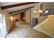 Bright living room showcasing beamed ceilings, a cozy fireplace, and a staircase at 8450 Mason Cir, Westminster, CO 80031