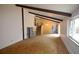 Spacious living room with vaulted ceilings and exposed beams, leading to a staircase at 8450 Mason Cir, Westminster, CO 80031