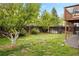 Lush backyard featuring a well-manicured lawn, mature trees, and fencing for privacy and outdoor enjoyment at 3312 Meadow Ave, Broomfield, CO 80020