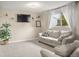 Relaxing basement with a comfortable couch, neutral carpet, and TV for entertainment at 3312 Meadow Ave, Broomfield, CO 80020