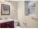 Clean bathroom with a white toilet, sink, dark cabinet, and a window to let light in at 3312 Meadow Ave, Broomfield, CO 80020