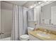 Cozy bathroom with tiled shower, vanity with gold accents, and a decorative mirror at 3312 Meadow Ave, Broomfield, CO 80020