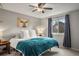 Comfortable bedroom with a ceiling fan, large window, and stylish blue accents at 3312 Meadow Ave, Broomfield, CO 80020