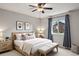 Light and bright bedroom featuring ceiling fan, neutral walls, and a comfortable bed with stylish pillows at 3312 Meadow Ave, Broomfield, CO 80020