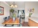 Open concept dining area with a wooden table set, hardwood floors, and connecting living space at 3312 Meadow Ave, Broomfield, CO 80020