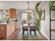 Cozy dining area with hardwood floors, a rustic table set, and a charming view to an outdoor patio at 3312 Meadow Ave, Broomfield, CO 80020