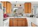 The kitchen features wooden cabinets and plenty of natural light from the window above the sink at 3312 Meadow Ave, Broomfield, CO 80020