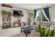 Comfortable living room featuring a large television, carpet, and bright decor at 3312 Meadow Ave, Broomfield, CO 80020