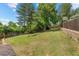 Large grassy backyard with a full fence and mature trees providing privacy and shade at 1487 W Fair Ave, Littleton, CO 80120