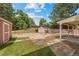 Backyard with patio, grass and mature trees providing privacy and shade from the summer sun at 1487 W Fair Ave, Littleton, CO 80120