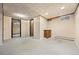 Finished basement featuring paneled walls, tile ceiling, recessed lighting, and a small utility sink at 1487 W Fair Ave, Littleton, CO 80120