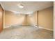 Unfinished basement featuring paneled walls, tile ceiling, recessed lighting, and two windows at 1487 W Fair Ave, Littleton, CO 80120