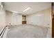 Unfinished basement featuring paneled walls, tile ceiling, recessed lighting and a small built in bookshelf at 1487 W Fair Ave, Littleton, CO 80120