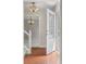 Bright foyer featuring tiled floor, modern chandelier, and decorative glass door leading to other rooms at 1487 W Fair Ave, Littleton, CO 80120