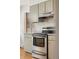 Modern kitchen featuring stainless steel appliances and light-colored cabinets and laminate countertop at 1487 W Fair Ave, Littleton, CO 80120