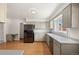 Spacious kitchen features gray cabinets, stainless steel appliances, laminate counters, and natural light at 1487 W Fair Ave, Littleton, CO 80120