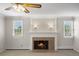 Cozy living room featuring a fireplace, neutral carpet, and bright sconces at 1487 W Fair Ave, Littleton, CO 80120