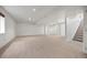 Large finished basement with neutral carpet, white walls, and access to stairs and storage at 5322 Shetland Ct, Highlands Ranch, CO 80130