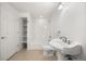 Bathroom with shower, toilet, and pedestal sink at 5322 Shetland Ct, Highlands Ranch, CO 80130